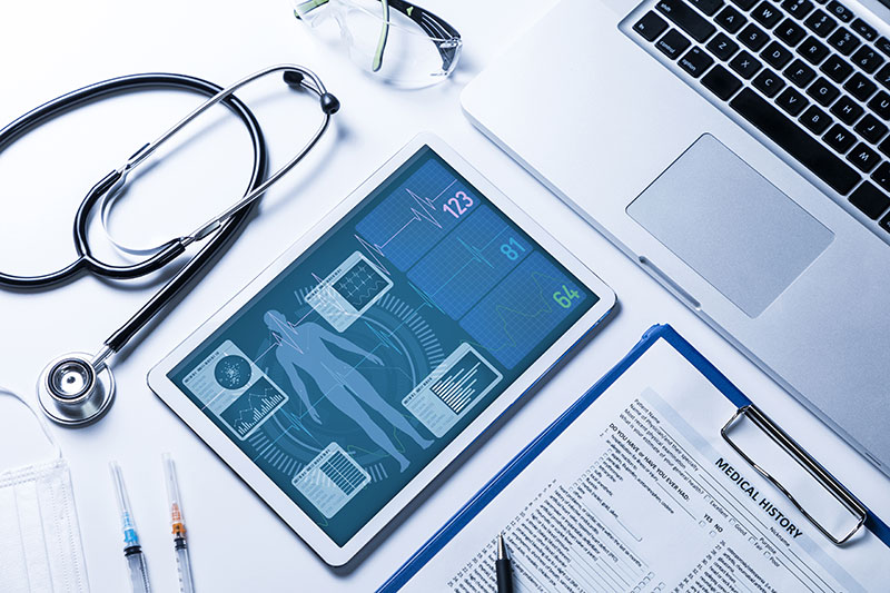 Vital signs on tablet screen, medical technology concept