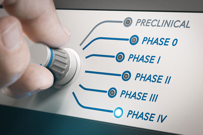 Hand turning knob to select phases of clinical trial.